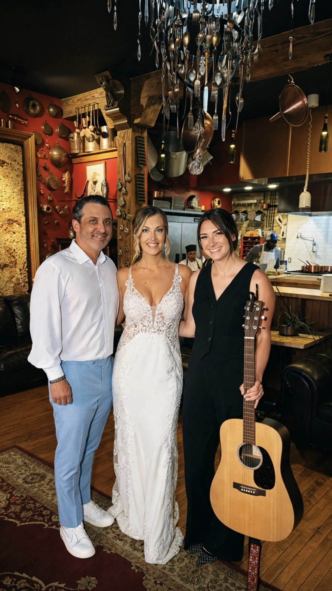 Anna Marie with a bride and groom at a rustic wedding venue